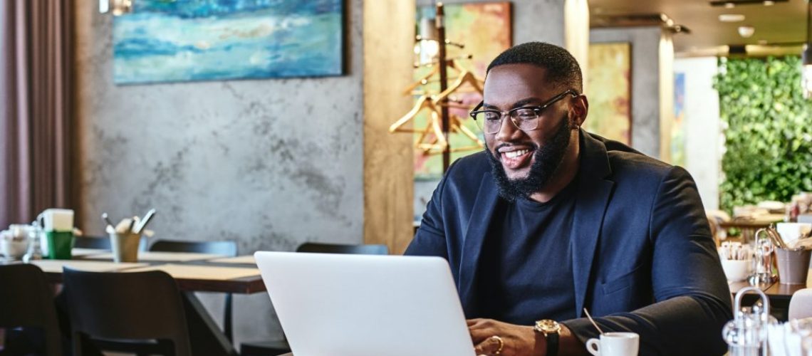 out-to-lunch-african-american-businessman-is-working-using-his-laptop-while-resting-in-the-cafe-1.jpg
